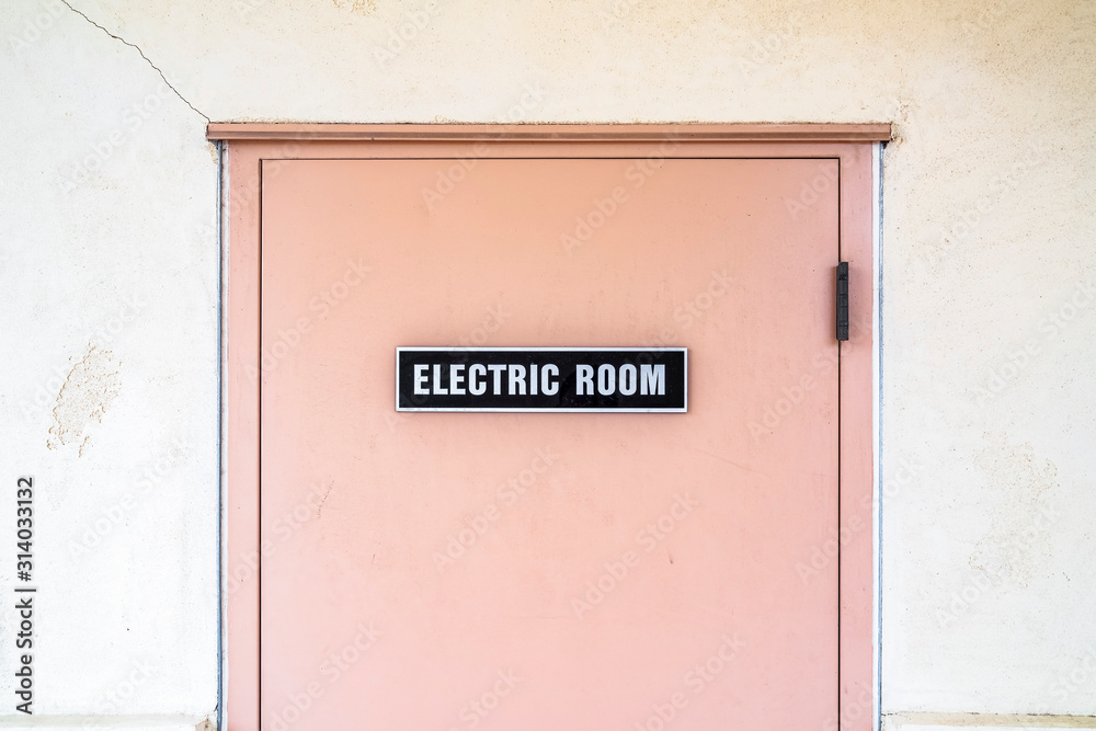 Close-up on electric room door with a sign