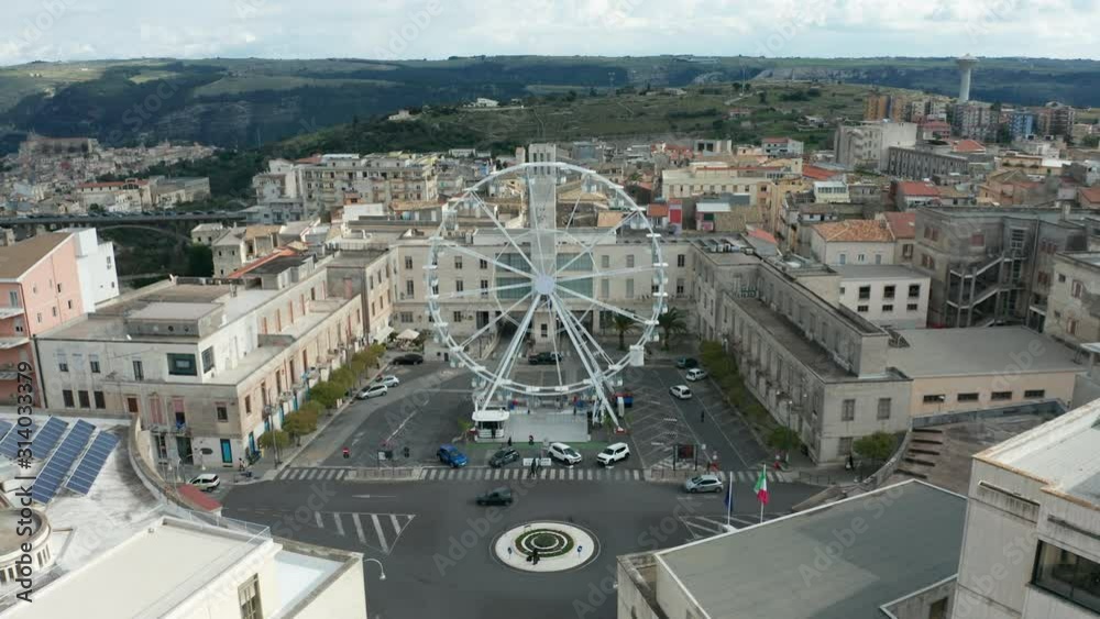 flying towards ferris wheel in Piazza Liberta in Ragusa Superior flying towards ferris wheel in Piazza Liberta in Ragusa Superior