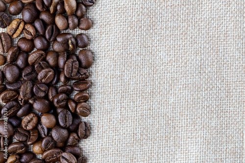 Border coffee beans on burlap. Creative minimal background.