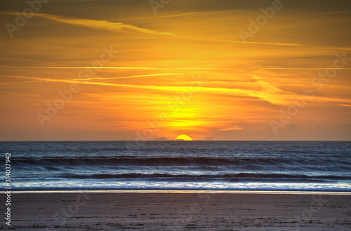 Last view of the sun as it sets over the horizon on Aberavon Beach in Port Talbot  South Wales  UK
