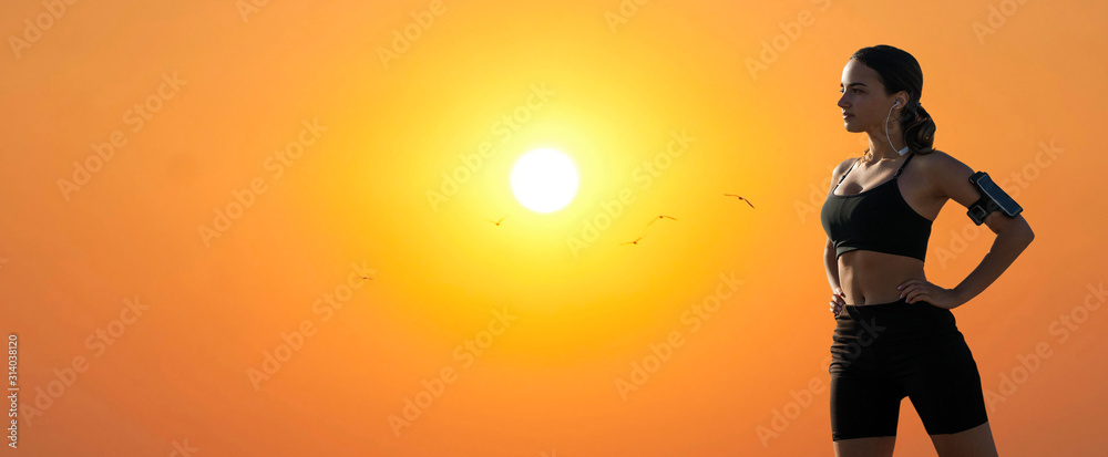 A thin athletic girl takes a break between classes on the background of beautiful sky at sunset, enjoys silence and freedom. A thin athletic girl takes a break between classes on the background of beautiful sky at sunset, enjoys silence and freedom.