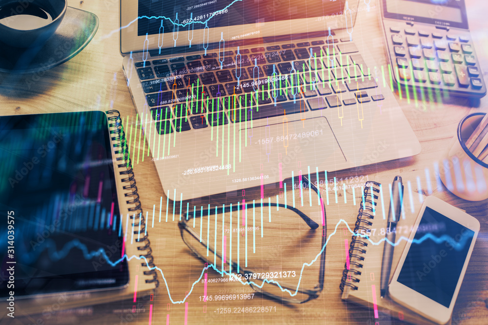 Double exposure of chart and financial info and work space with computer background. Concept of international online trading. Double exposure of chart and financial info and work space with computer background. Concept of international online trading.