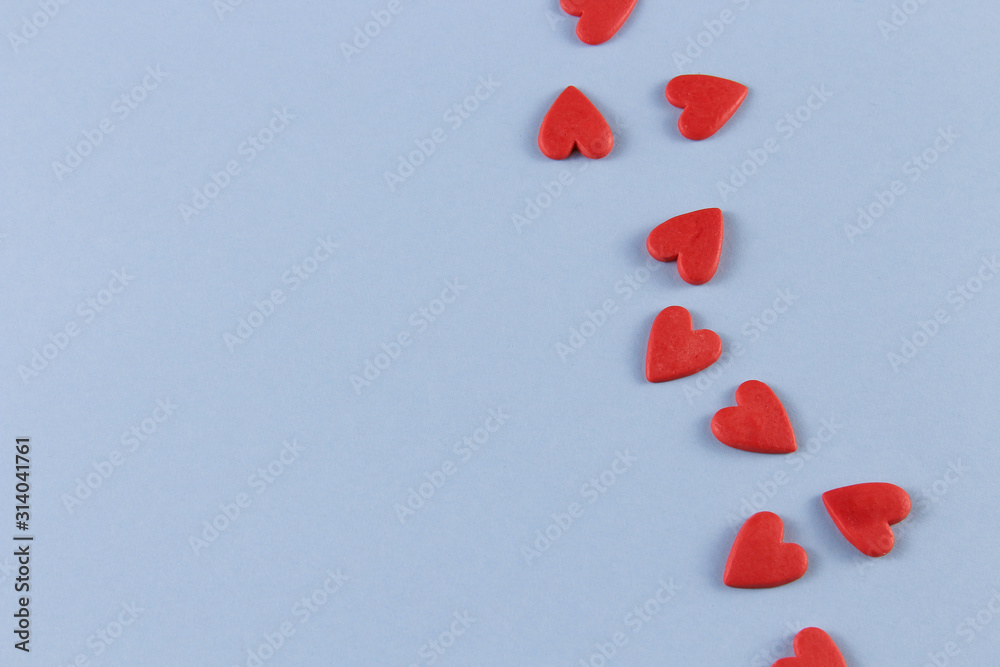 red hearts on a blue background with room for text