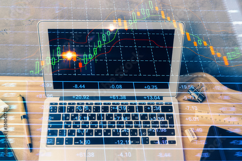 Double exposure of forex graph and work space with computer. Concept of international online trading.