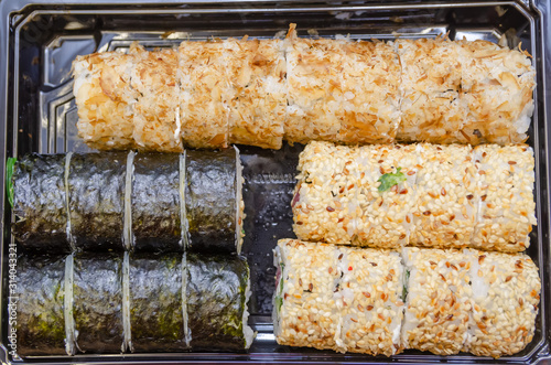 Set sushi Toto Maki, Bonito Maki, Akito Maki on a wooden background close up. Top view photo