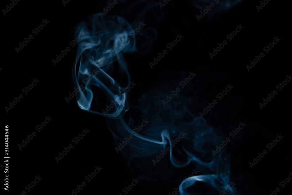 Beautiful abstract blue smoke with copy space on black background. Smoke background for art design or drawing. Abstract figure of the smoke Beautiful abstract blue smoke with copy space on black background. Smoke background for art design or drawing. Abstract figure of the smoke