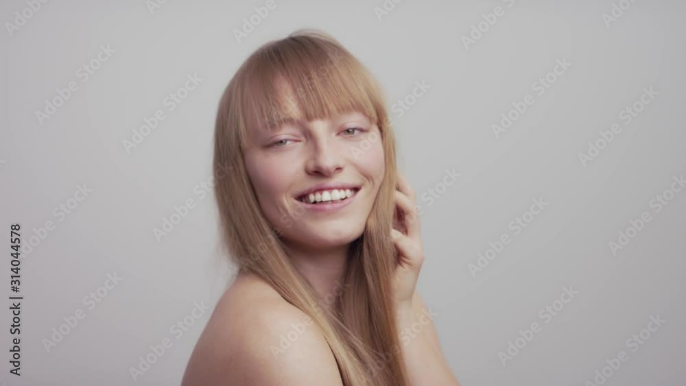 Model girl smiling and posing in front of camera in professional studio Model girl smiling and posing in front of camera in professional studio