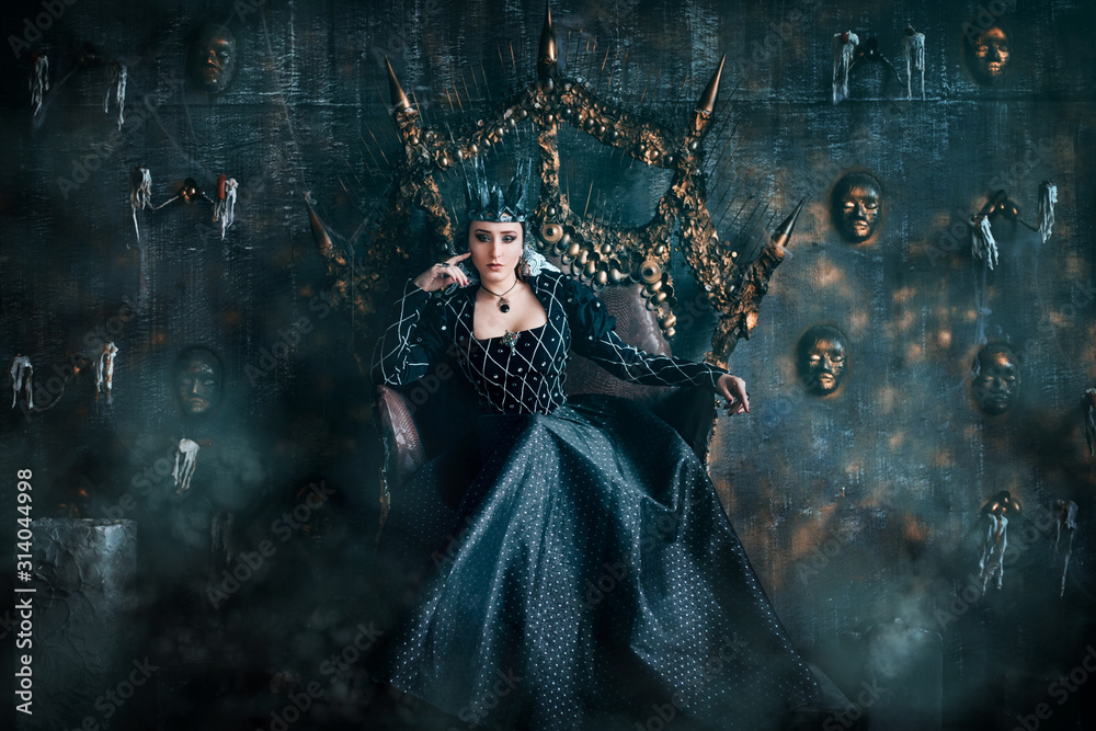Evil Queen in a black dress. Beautiful girl in the crown sits on the throne  Stock Photo | Adobe Stock