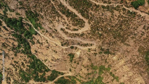 Aerial drone flying over road lanes near armenian mountains and fields sky, landscape in summer. Flying over armenian fileds and houses in the coutryside
