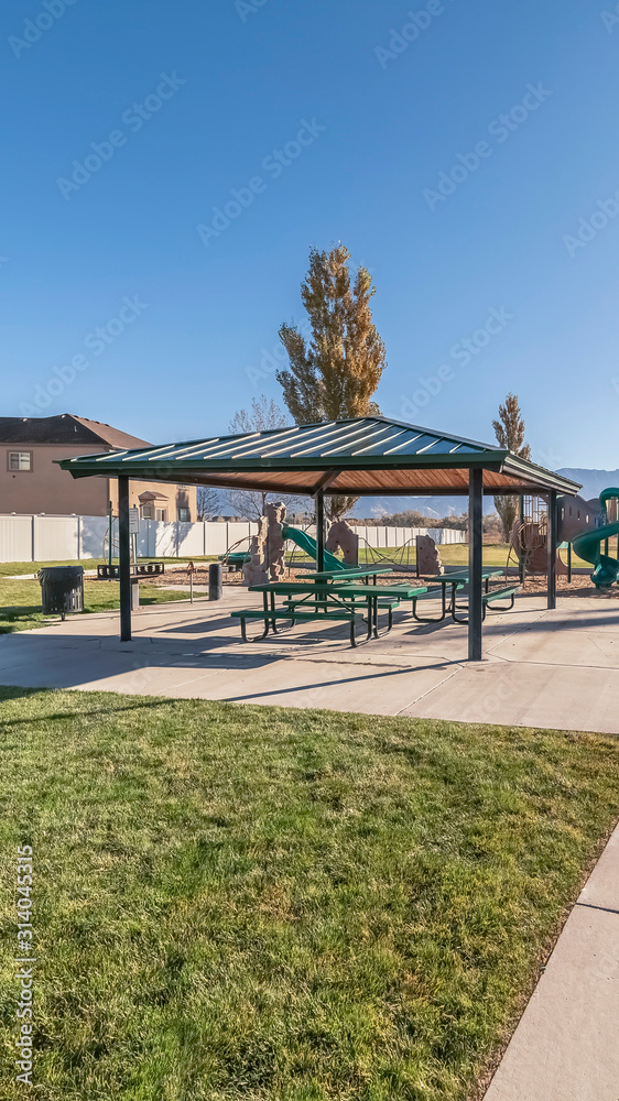 Vertical frame Covered picnic area and kids playground near sunrise