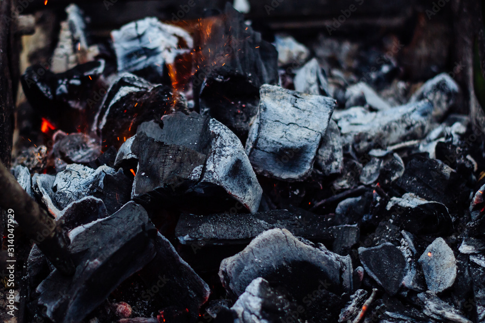 Smoldering coals on the grill with sparks. Bonfire Texture Smoldering coals on the grill with sparks. Bonfire Texture