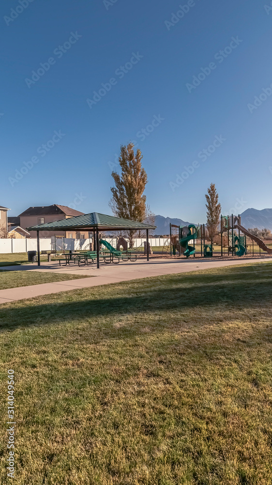 Vertical frame Kids playground and picnic area in an urban park Vertical frame Kids playground and picnic area in an urban park