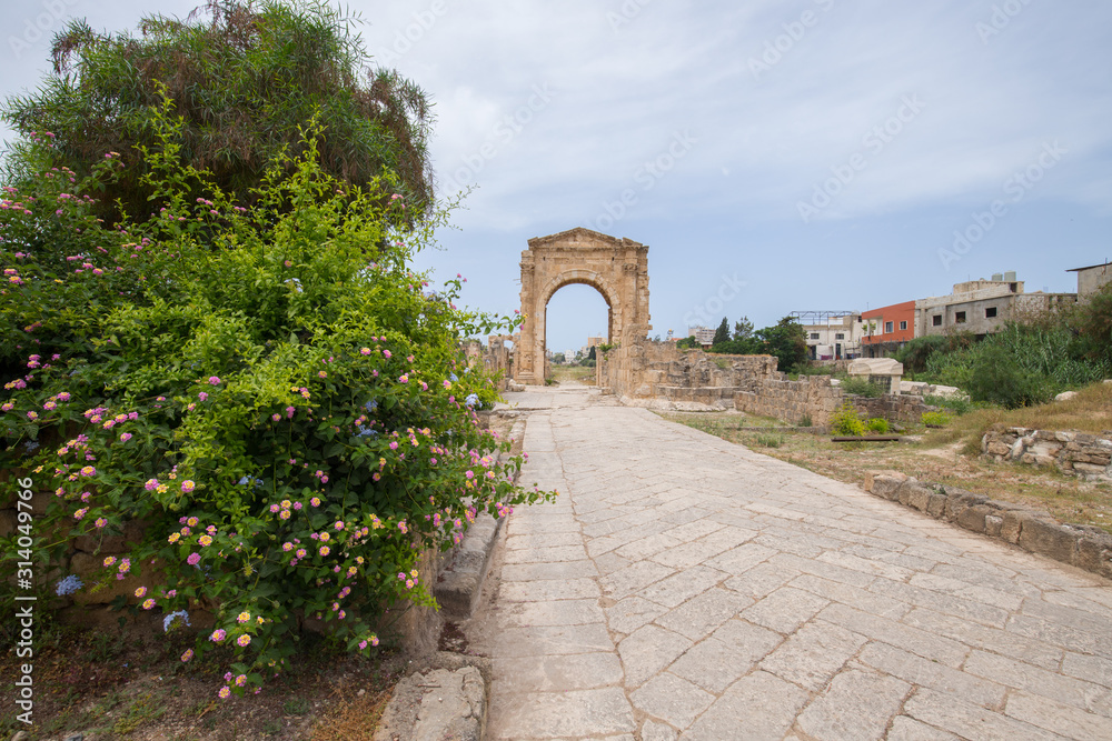 The arch of triumph and the Byzantine road. Roman remains in Tyre. Tyre is an ancient Phoenician city. Tyre, Lebanon - June, 2019