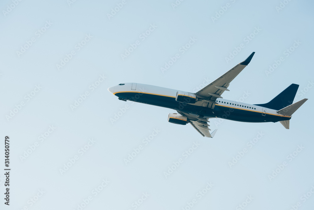 Fototapeta premium Low angle view of aeroplane with blue sky at background