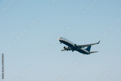 Low angle view of airplane taking off in clear sky