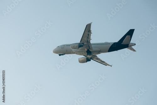 Low angle view of flight departure of plane in blue sky