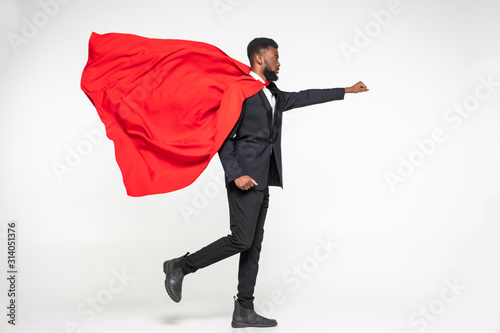 Young african businessman hero run with fist up isolated on white background