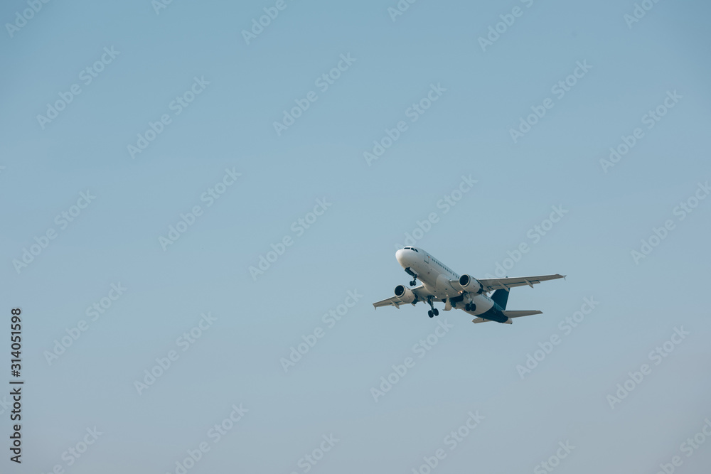 Jet plane taking off with blue sky at background Jet plane taking off with blue sky at background