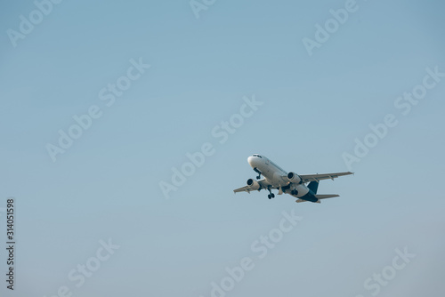 Jet plane taking off with blue sky at background