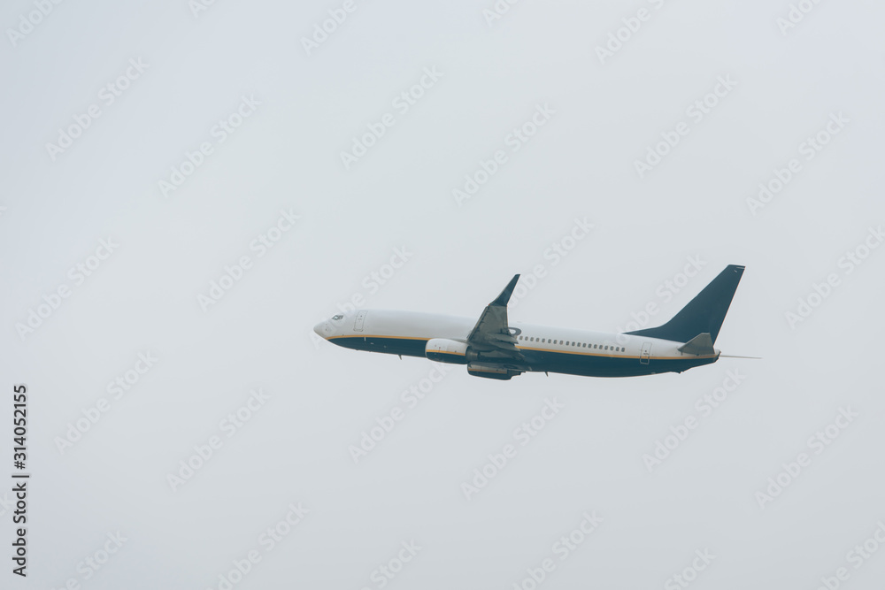 Low angle view of airplane taking off in cloudy sky