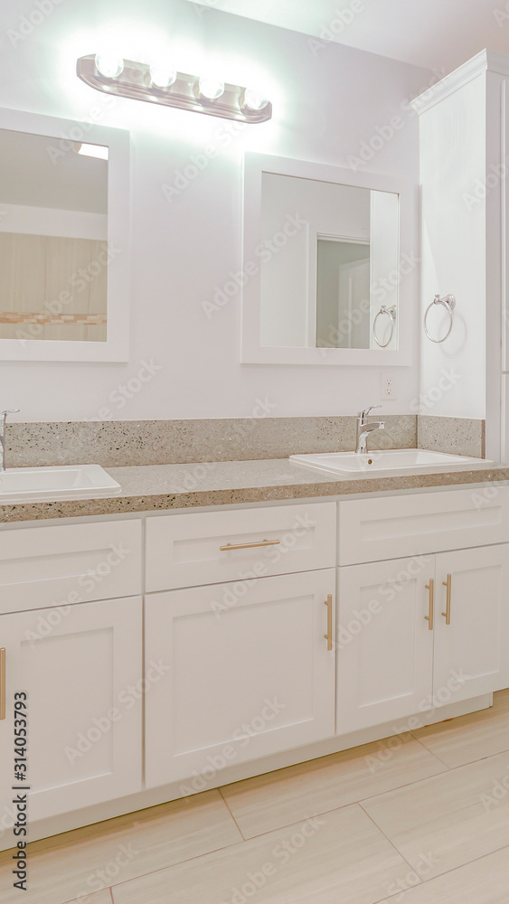 Vertical frame Bright white bathroom with white towel Vertical frame Bright white bathroom with white towel