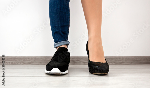 Two different types of shoes on the woman's foots