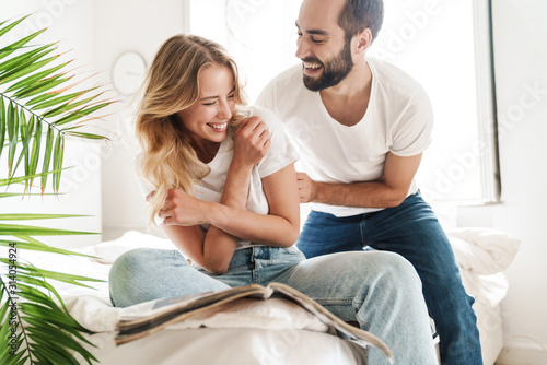 Happy young couple in love relaxing on a couch at the living room