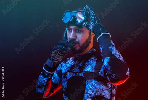Man scuba diver portrait. Man in diving suit and diving mask