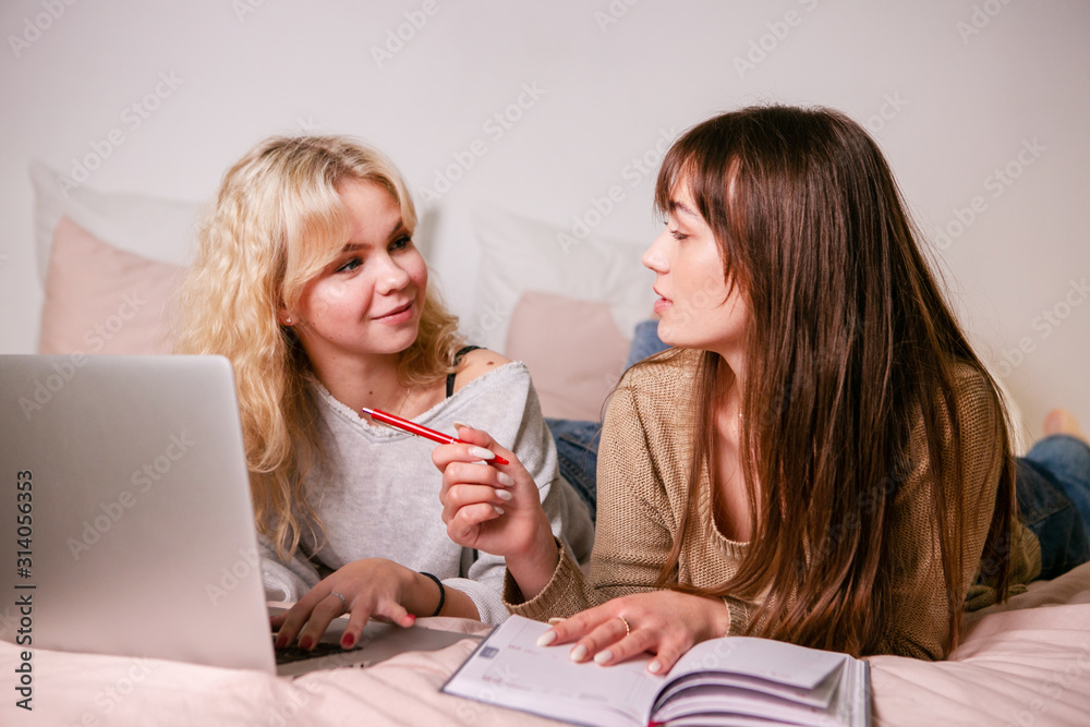 Smiling girls student study at home with laptop Smiling girls student study at home with laptop