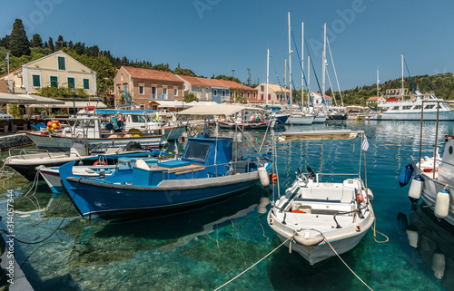 Wonderful summer day of Zavalata Beach, Fiskardo village and harbor. Kefalonia island, Greece, Europe. Beautiful Spring view on seascape with Incredible turquoise water and fishing boats.