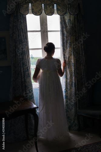 Regency woman in dark room photo