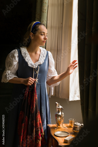 Renaissance peasant woman waiting at her window