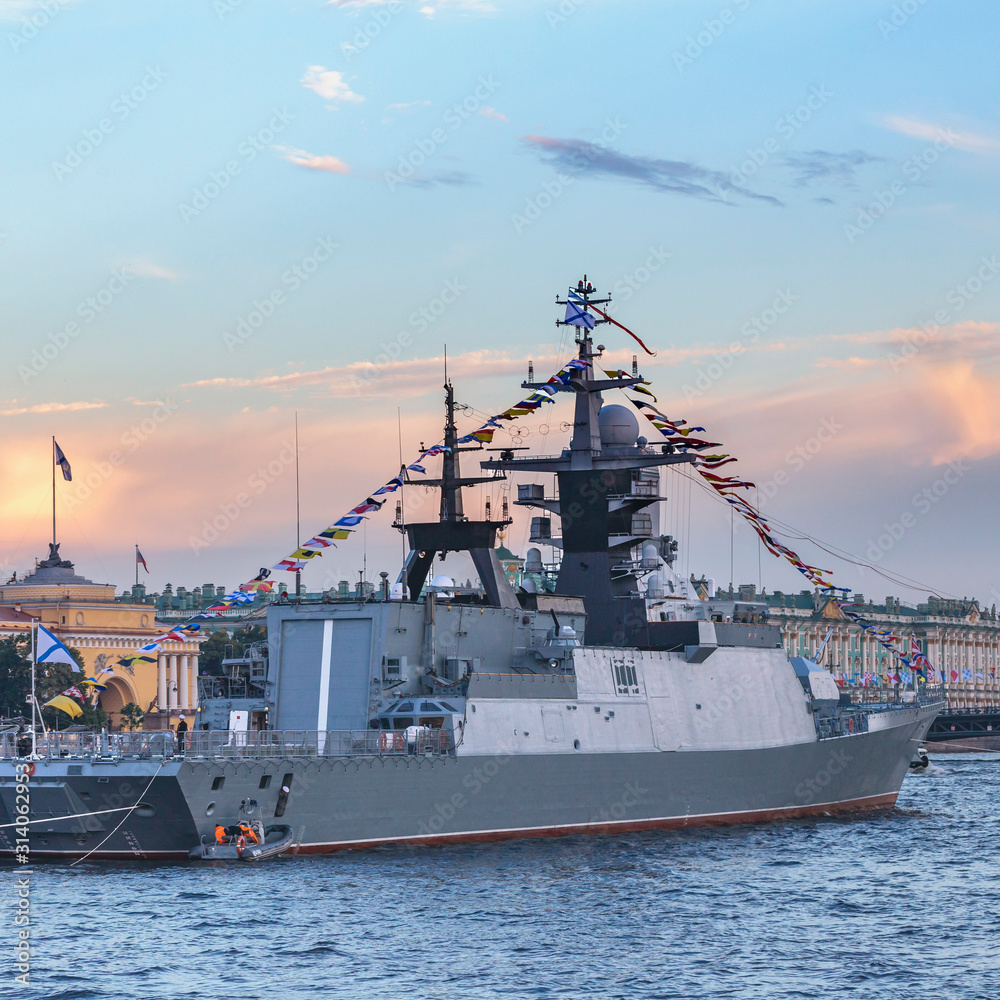 military ship on Neva river in St. Petersburg against the blue sky and the city military ship on Neva river in St. Petersburg against the blue sky and the city