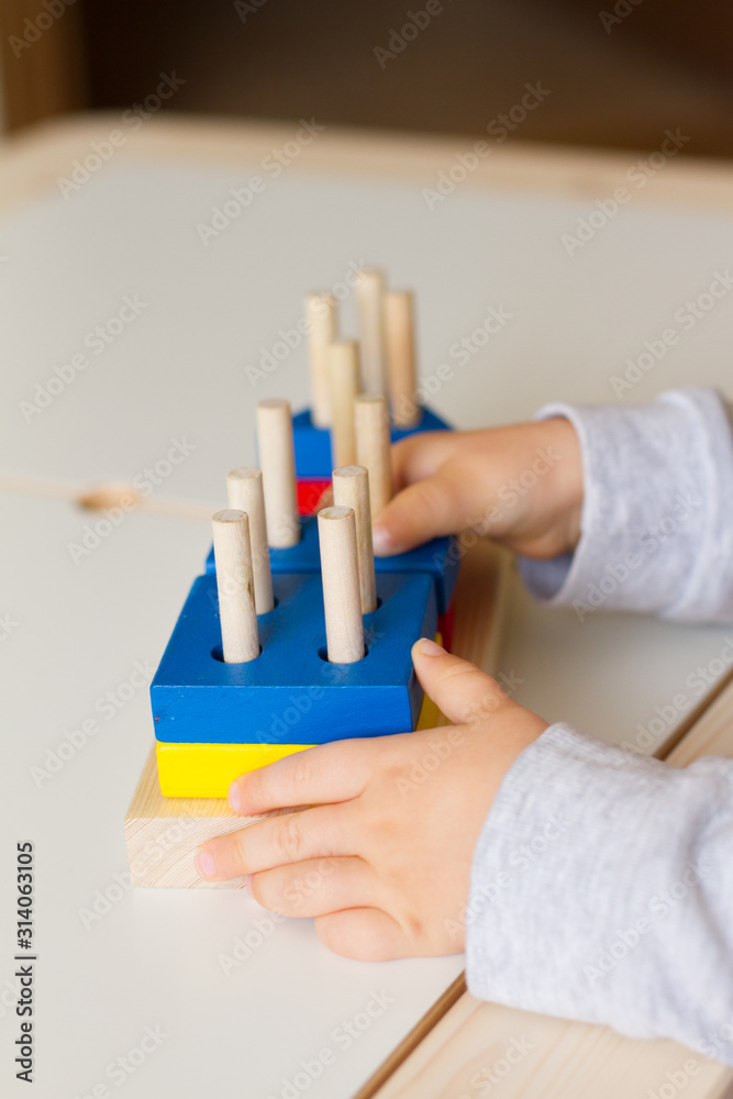 Toy made of wood for the study of shapes and colors. Useful game for a child on a white table. Montessori Education. Materials for the school. Materials on geometry. the concept of teaching children.