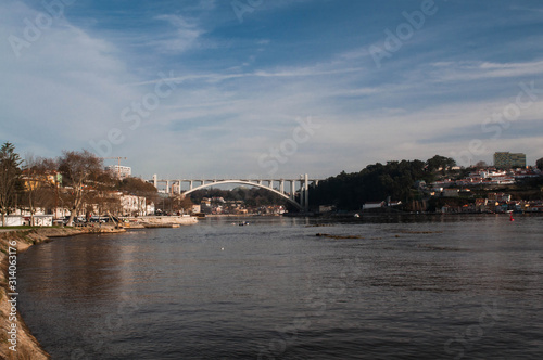  enjoying a beautiful early spring day next to the Douro River and the Arrabida Bridge at Porto City in Portugal © Elena