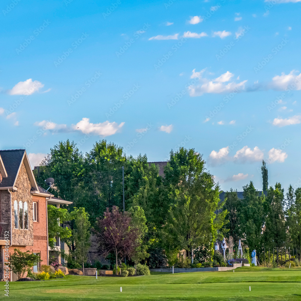 Square frame Luxury houses and golf course with mountain and blue sky in the background