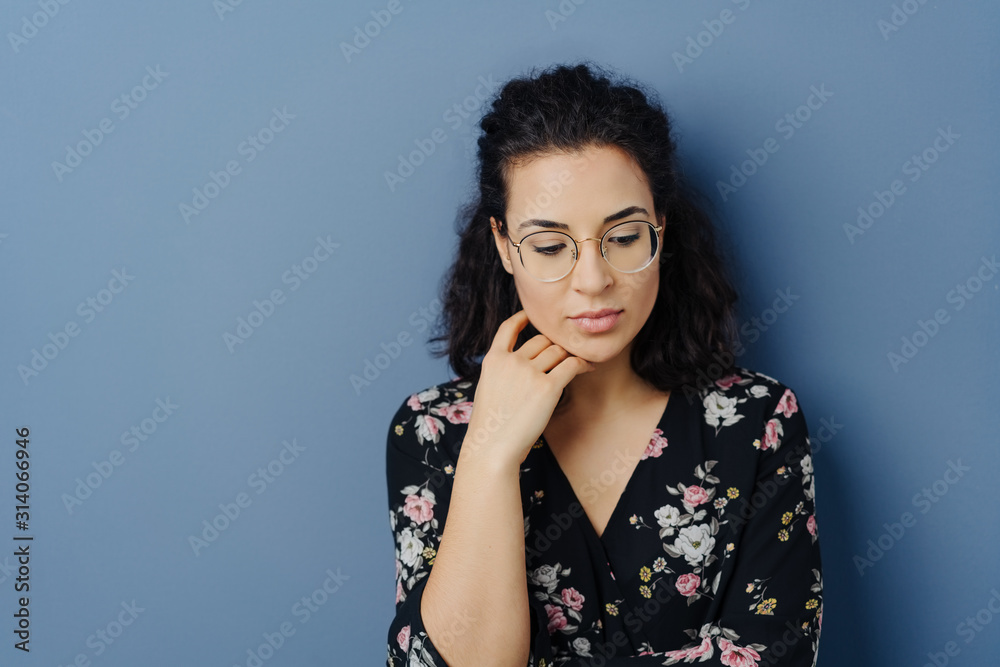 Thoughtful sad young woman with downcast eyes Thoughtful sad young woman with downcast eyes