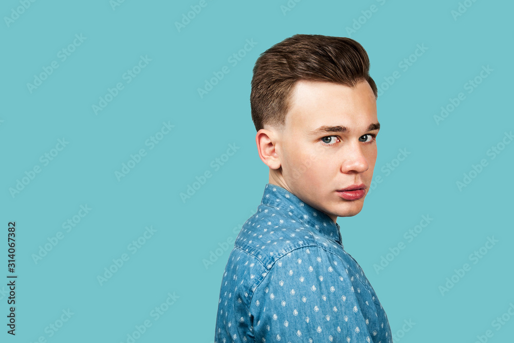 Fototapeta premium serious young guy portrait dressed in black t shirt looking at the camera