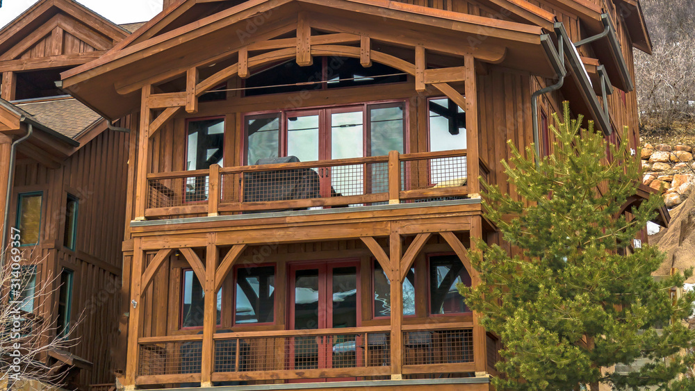 Pano Exterior of cabin in Park City Utah with brown wood exterior wall and balconies Pano Exterior of cabin in Park City Utah with brown wood exterior wall and balconies