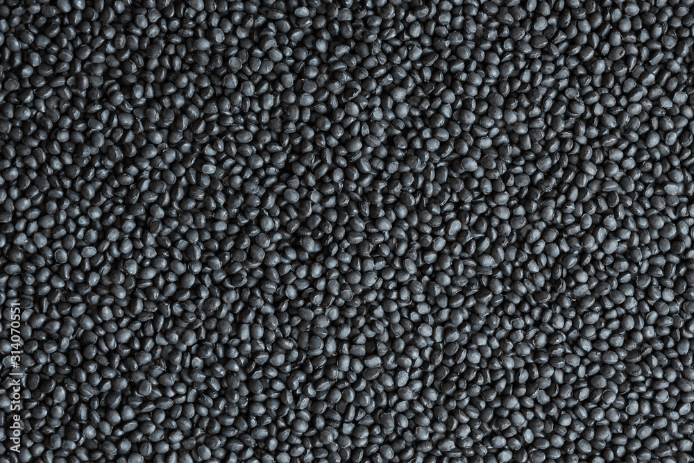 Black polymer dye in granules, background texture Black polymer dye in granules, background texture