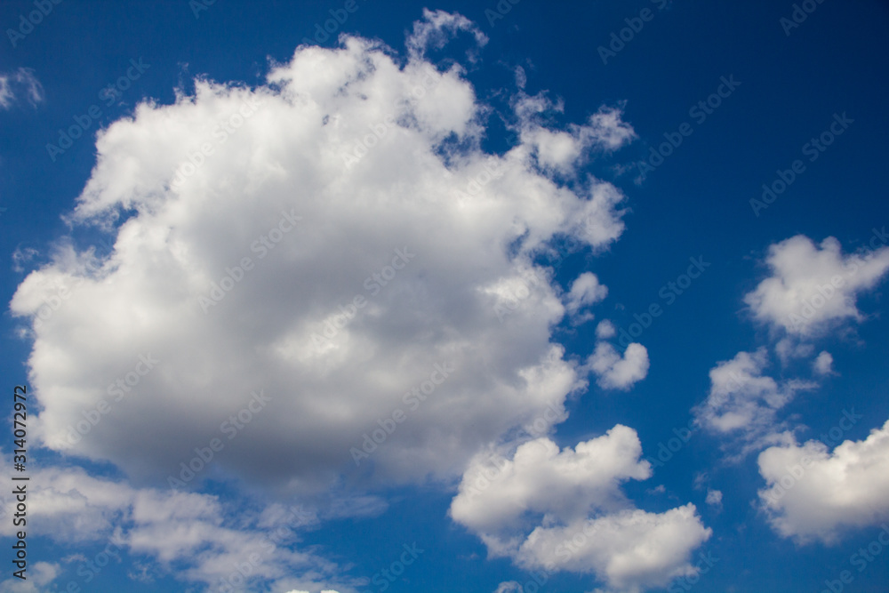 Obraz premium white fluffy clouds on a background of blue sky