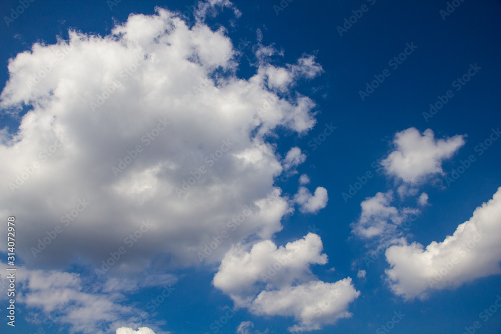 white fluffy clouds on a background of blue sky white fluffy clouds on a background of blue sky