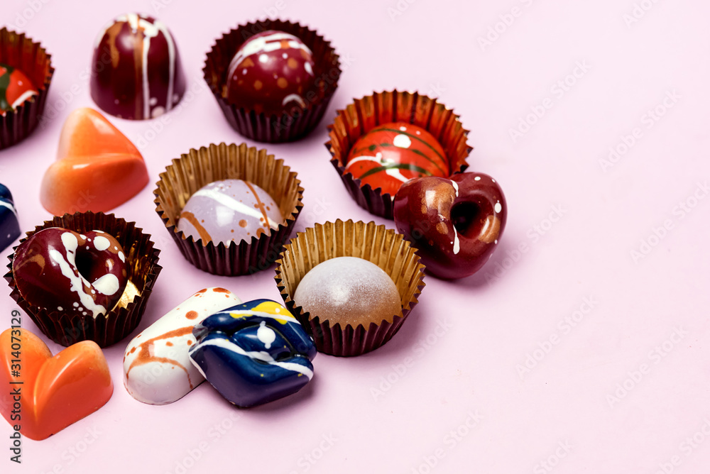 Luxury Bonbons Painted with Differents Colors on Pink background Beautiful and Exclusive Handmade chocolate Candy Horizontal Luxury Bonbons Painted with Differents Colors on Pink background Beautiful and Exclusive Handmade chocolate Candy Horizontal