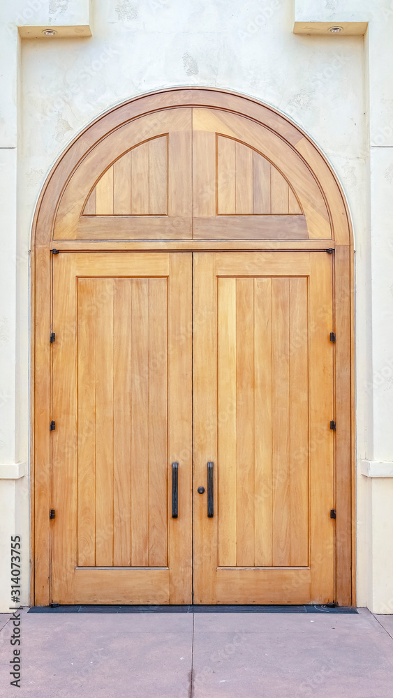 Vertical Double arched wooden entrance door of exterior