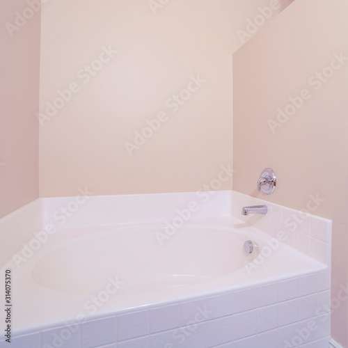Square frame Interior of a small bright bathroom with bathtub
