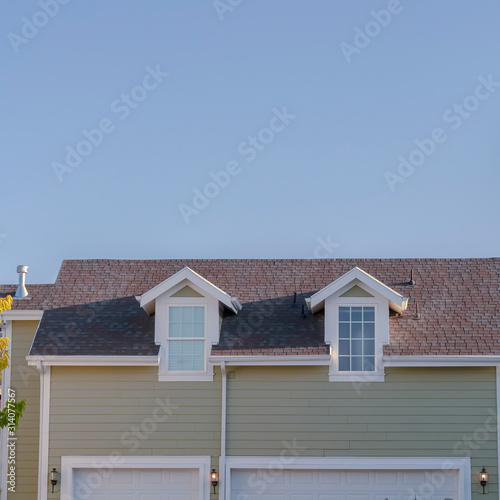 Square frame Two small dormer windows in an urban house