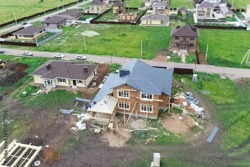 Holiday village, view from above. House with a new roof made of photo