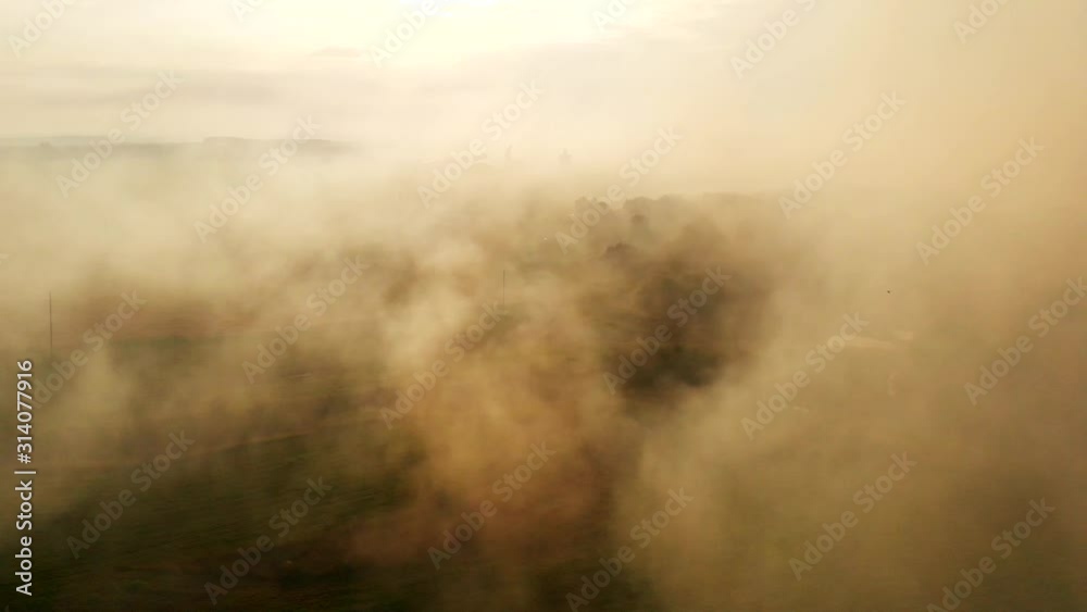Smoke over forest fire in autumn, aerial view. Wild fire, trees burning, smoke above the trees. Siberian wildfire forest. A huge cloud of smoke from a field fire Smoke over forest fire in autumn, aerial view. Wild fire, trees burning, smoke above the trees. Siberian wildfire forest. A huge cloud of smoke from a field fire