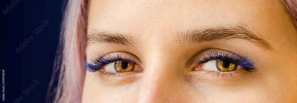 The lashes are black with splashes of blue.