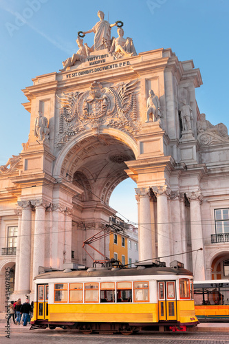 Bild auf Leinwand Lisbon, Portugal, a traditional yellow tram passing in front of the Rua Augusta